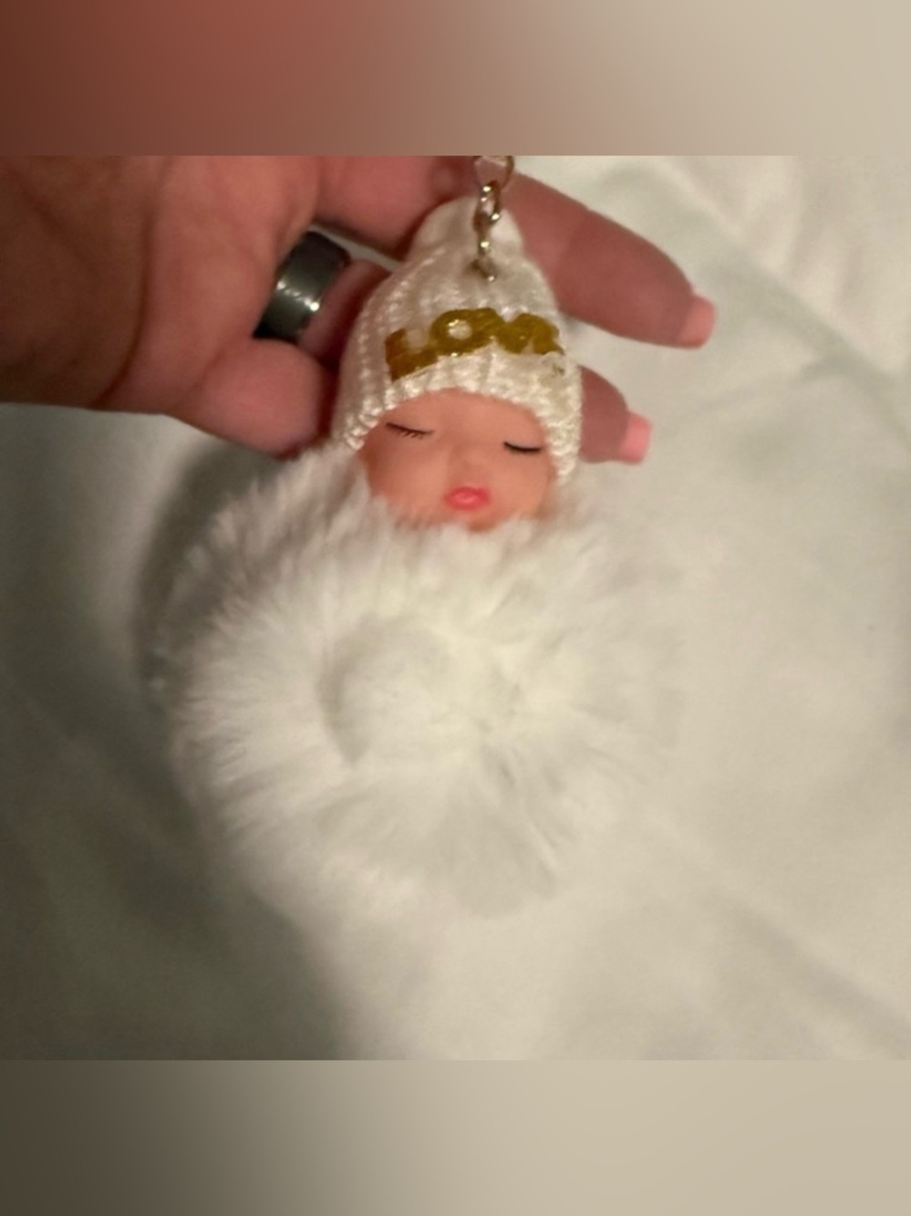 Keychain Baby Doll with White fluffy Fur and Love on its hat!